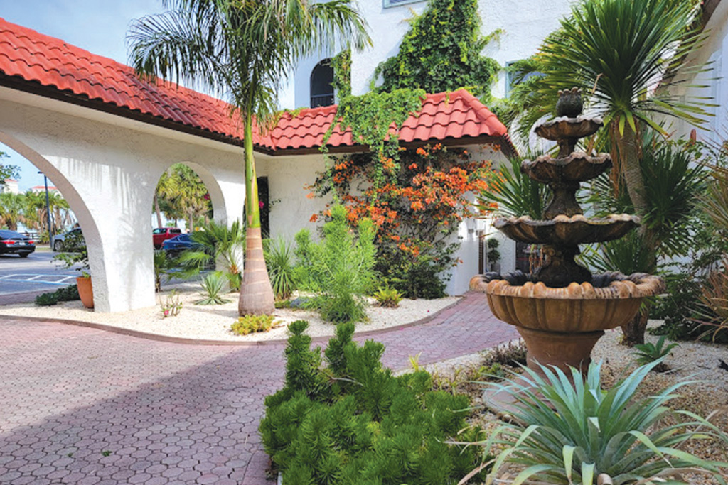 Courtyard with fountain and palms outside a Florida home
