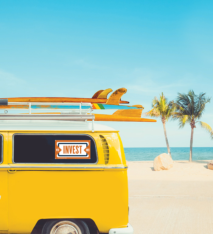 Your Residential Property Management Partner-FL Yellow van with surfboards and an Invest sign parked on a Florida beach
